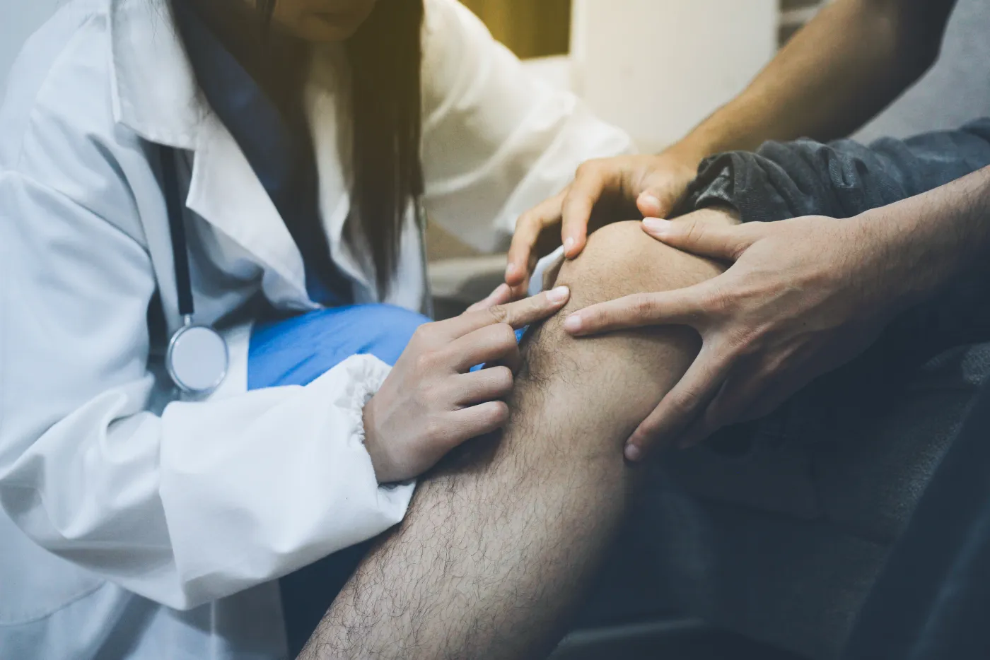 Dr. Anton examining a patient's lower leg during a chronic venous insufficiency evaluation.